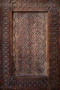 Vertical image of a fragment of a wooden front door in an old building