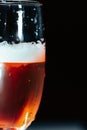 Vertical image of a glass of Champaign in the dark background with red and blue lights