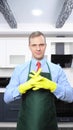 A vertical image. handsome man in tie and apron wearing rubber gloves