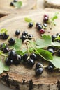 Vertical image.Heap of blackcurrant on the wooden board
