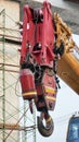 Vertical image of a hook attached to the end of a lifting crane