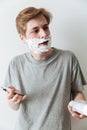 Vertical image of Incomprehensible man in shaving foam