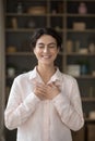 Vertical image joyful Hispanic woman feeling thankful.