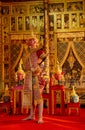 Vertical image of Khon or traditional Thai classic masked from the Ramakien with Red giant character stand with spear and look