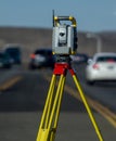 Vertical image of Land survey equipment set up on road with road