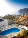 Vertical image of luxurious villa with swimming pool on hte mountain edge at the ocean coast Royalty Free Stock Photo