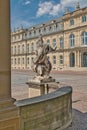 Vertical image of a majestic stone statue standing in the public square of Stuttgart, Germany