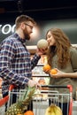 Vertical image of man giving smell melon to his woman