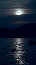 Vertical image of moonpath over the sea waves. Moon shining and reflecting on ocean surface Royalty Free Stock Photo