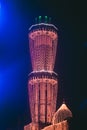 Vertical image of Mosque in Pakistan decorated with orange fairy lights on the event of 12 Rabi ul Awal