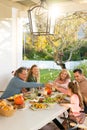 Vertical image of multi generation caucasian family eating outdoor dinner Royalty Free Stock Photo