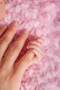 Preemie holding mother`s finger