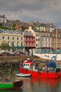 Vertical image of the old iconic traditional waterfront shophouses with red vessel at Cobh, Republic of Ireland Royalty Free Stock Photo