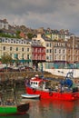 Vertical image of the old iconic traditional waterfront shophouses with red vessel at Cobh, Republic of Ireland