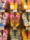 Vertical Image of Out of Focus of Vibrant Color Beach Sandals Hanging in the shop