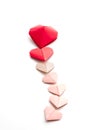 Valentine`s Day Origami Hearts Arranged in Shape on White Background