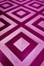 Vertical image of pink and purple colored geometric pattern wooden floor Royalty Free Stock Photo