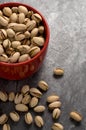 Pistachios in a Red Cup on Granite Counter