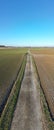 Straight Through the Seasons: A Path Between Harvested and Sown Fields Royalty Free Stock Photo