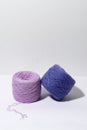 Vertical image of purple knitting yarn with shadow from hard light on gray isolated background. Conception of small business and Royalty Free Stock Photo