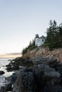 Vertical image of the rocky coast of Mt Desert Island and the Bass Head Harbor Lighthouse in Maine, USA Royalty Free Stock Photo