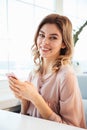 Vertical image of Smiling blondy woman in blouse