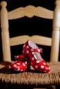 Vertical image of some traditional Spanish shoes on a typical flamenco tablao chair, using artificial lighting Royalty Free Stock Photo