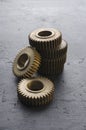 Vertical image.Stack of bronze colored gears on the dark surface Royalty Free Stock Photo