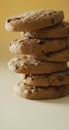 Vertical image of stack of chocolate chip cookies on yellow background Royalty Free Stock Photo