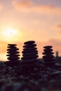 Balanced pebble pyramid silhouette on the beach at sunset Royalty Free Stock Photo