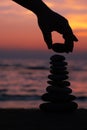 Vertical image of stacking rocks on the beach with a sunset ocean Royalty Free Stock Photo