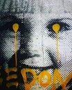 Vertical image of a street art portrait of a little girl with yellow dots in the eyes