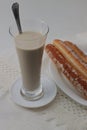 Close-up of a long glass of horchata de chufas with some fartons as a side Royalty Free Stock Photo