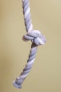 Vertical image of a thick twisted rope. Gymnastics sports equipment tied in a knot at the end