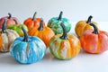vertical image top view group of small pumpkins painted in different bright colors on white Royalty Free Stock Photo
