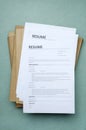 Vertical image.Top view of stack of resume forms and folders on the office blue desk