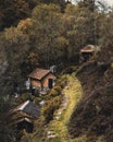 Vertical image of traditional houses in a village a the side of a mountain surrounded by trees Royalty Free Stock Photo