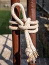 Vertical image of two metallic tubes of gate tightly closed with rope