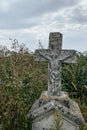 Vertical image. Unnamed gravestone on old abandoned city cemetery. Weathered stone cross on abandoned graveyard Royalty Free Stock Photo