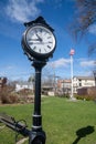 Vertical image of a vintage village clock located on Railroad Green in downtown