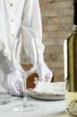 Vertical image.Waiter making some preparation for guests.Closeup of glass and bttle of white wine Royalty Free Stock Photo