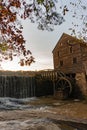 Vertical image of a waterfall at the historic Yates Mill County Park in Wake County, North Carolina at sunset in autumn Royalty Free Stock Photo