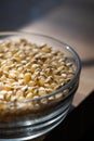 Yellow popcorn kernels in a glass bowl on a kitchen counter Royalty Free Stock Photo