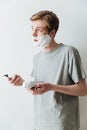 Vertical image of Young Incomprehensible man in shaving foam