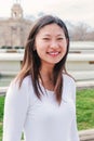 Vertical individual portrait of one joyful asian high school girl student looking smiling at camera. Front view of young Royalty Free Stock Photo