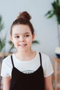 vertical indoor portrait of happy preteen girl posing in modern scandinavian interior