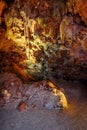 Vertical interior of Damlatas cave in Alanya Turkey. Brown stone surfaces of stalactites and stalagmites underground, Royalty Free Stock Photo