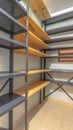 Vertical Interior of a small empty closet with metal and wood shelves for clothes