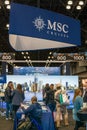 Vertical interior view of visitors enjoying the MSC Cruises pavilion at the New York Travel and