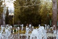 Vertical jets of fountain form circle. Turquoise water of pond as decoration of city park